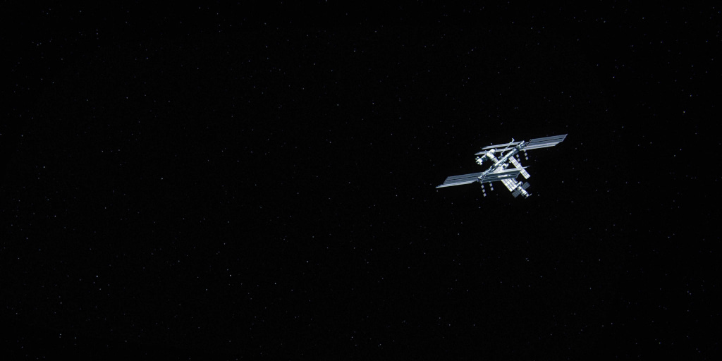 Orbit 41. Photo by Norbert Kowalczyk on Unsplash. Photo shows manmade structure floating against black background of outer space.