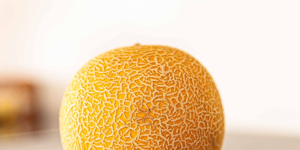 The Locked Cupboard. Photo by Kenny Timmer on Unsplash. Shows the yellow dome of a honeydew melon.
