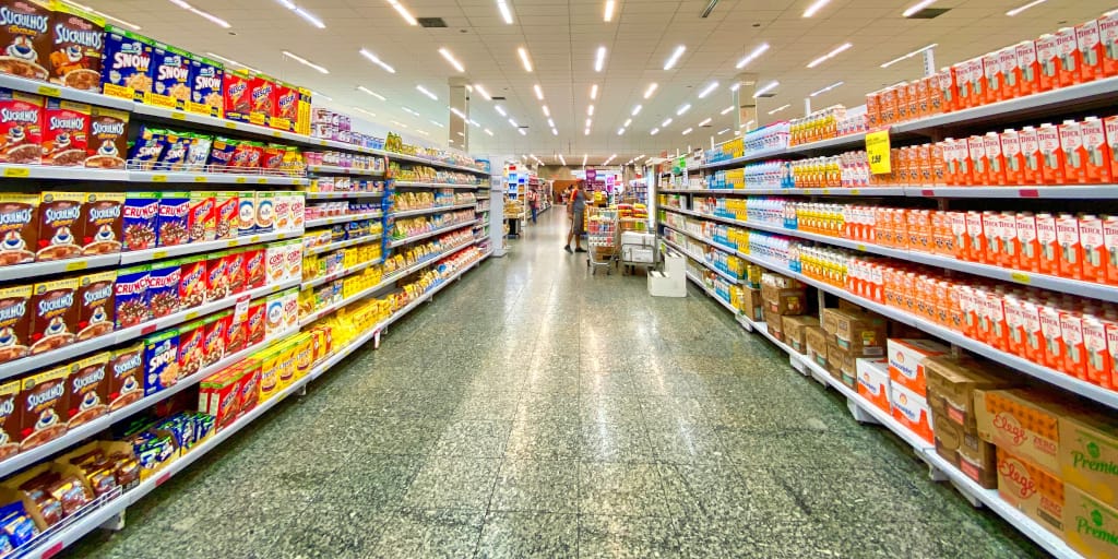 Outer Demons_Photo by Nathália Rosa on Unsplash. Shows supermarket shelves.
