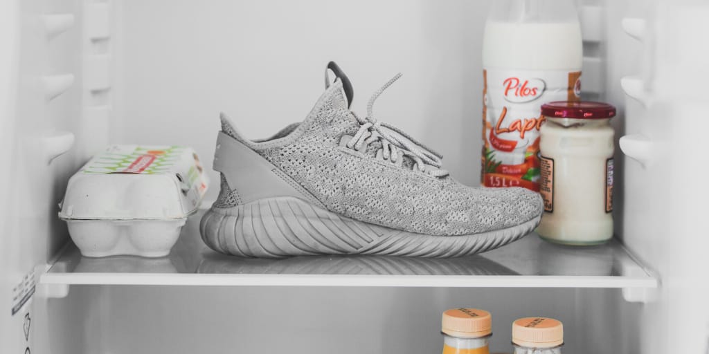 A Can of Coke. Photo by Alexandru Acea on Unsplash. Photo of white trainer inside a fridge.
