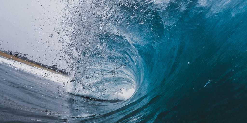 A Personal History of Everything. Photo by Jeremy Bishop on Unsplash. Shows a large blue wave crashing.