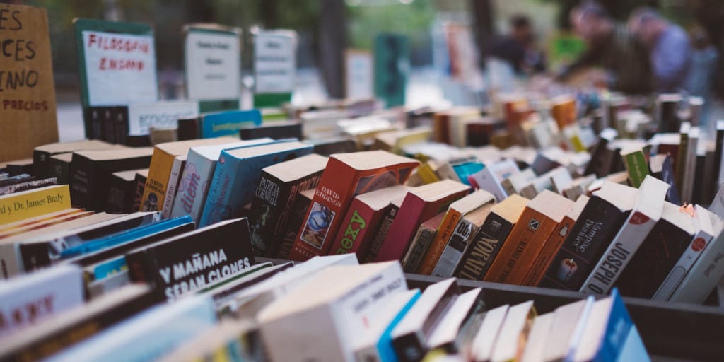 Yerma at the Market. Photo by Freddie Marriage on Unsplash. Shows well-stocked book stall.