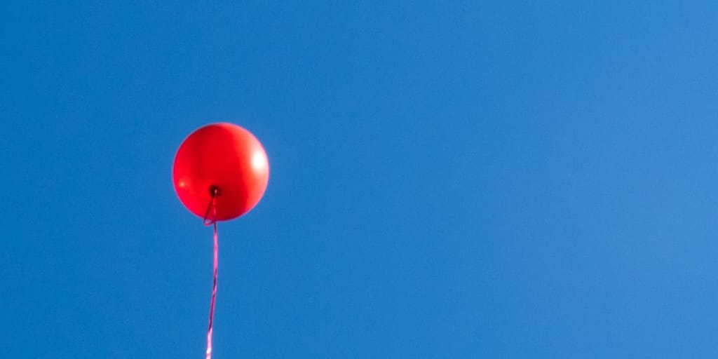 ll He Could Do_Photo by Olga Subach on Unsplash. Shows red balloon against cloudless blue sky.