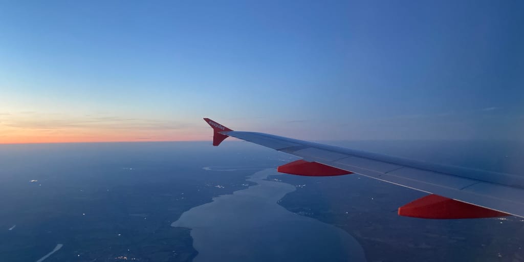 A Last Date. Photo by Judy Darley. Shows view from aeroplane at sunset.